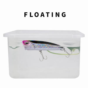 Water test showing a floating topwater popper in a clear container.