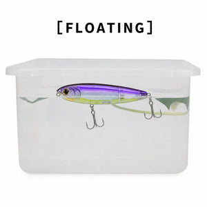 Water test showing a floating pencil lure in a clear container.