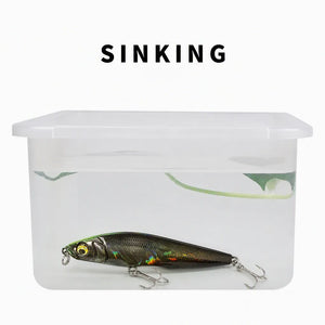 Water test showing a sinking pencil lure in a clear container.