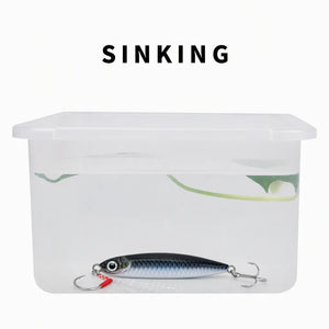Water test showing a sinking metal jig in a clear container.